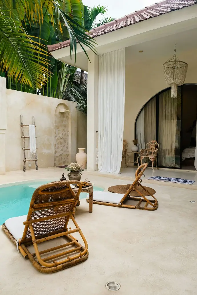 A pool with a chair and a table next to it